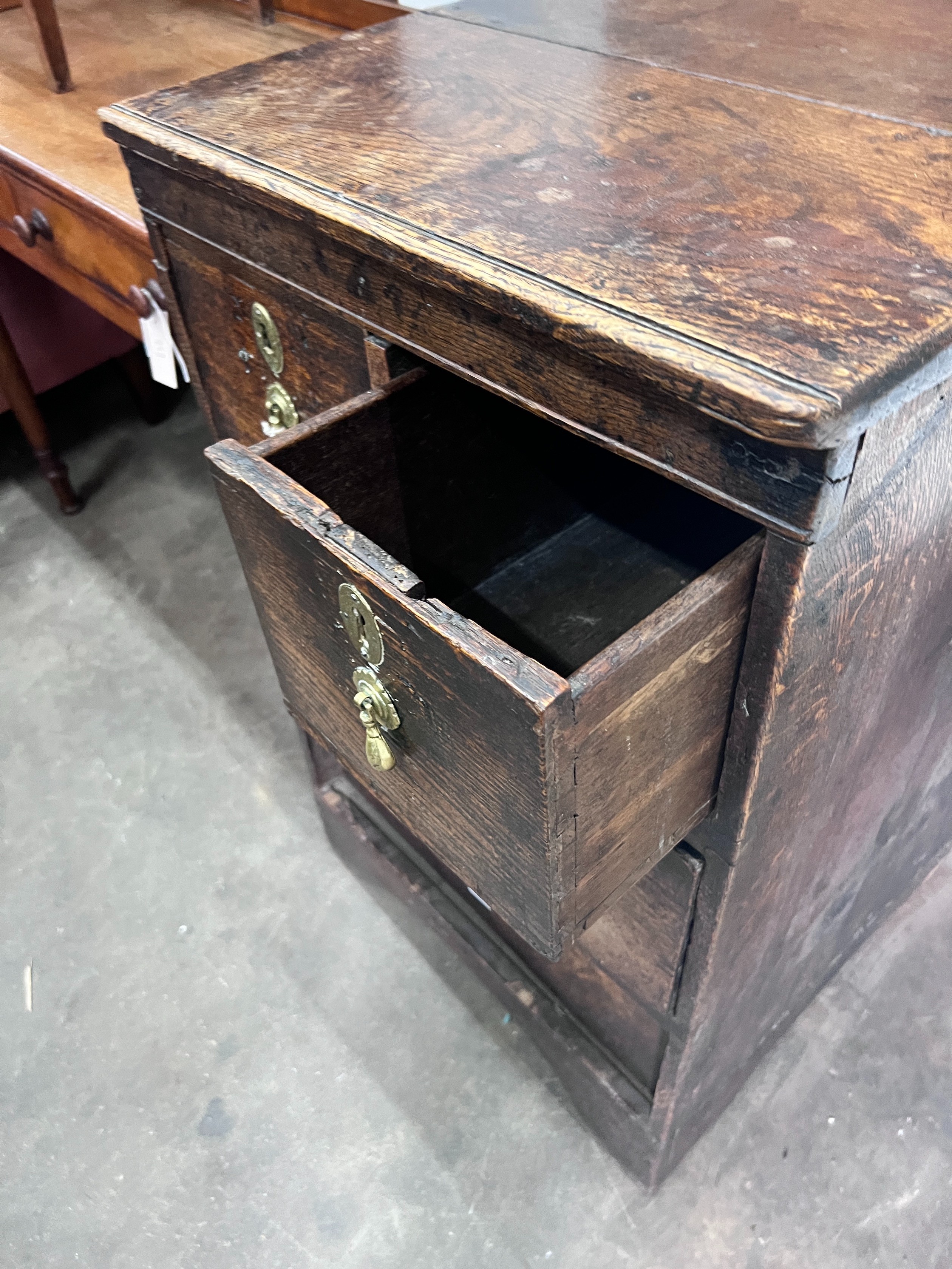An 18th century oak four drawer chest, (altered) width 54cm *Please note the sale commences at 9am.